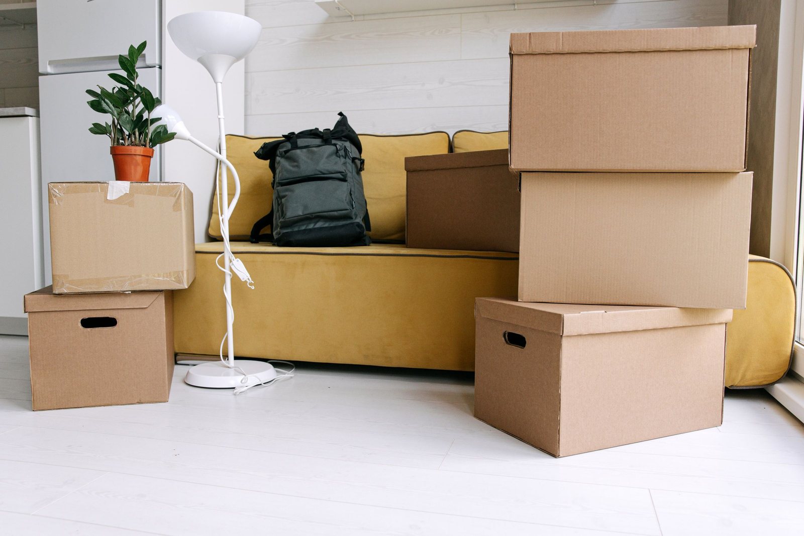 Moving boxes stacked in a flat living room ready for an apartment move