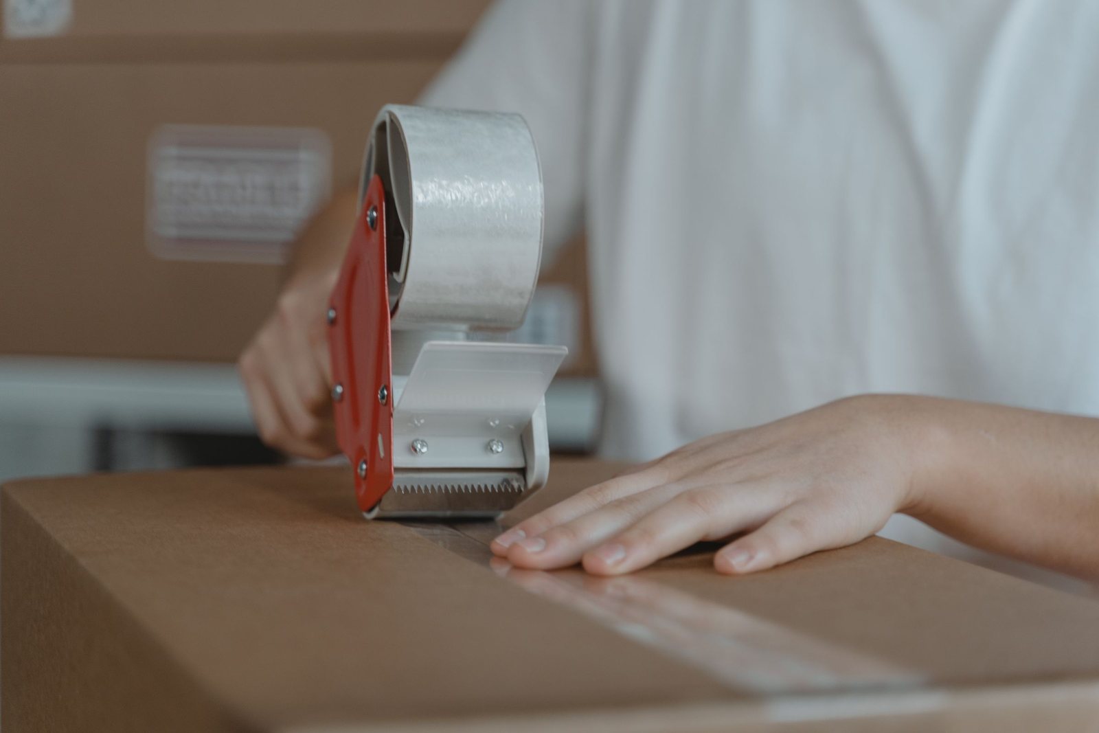 Sealing a cardboard box with packing tape before a move